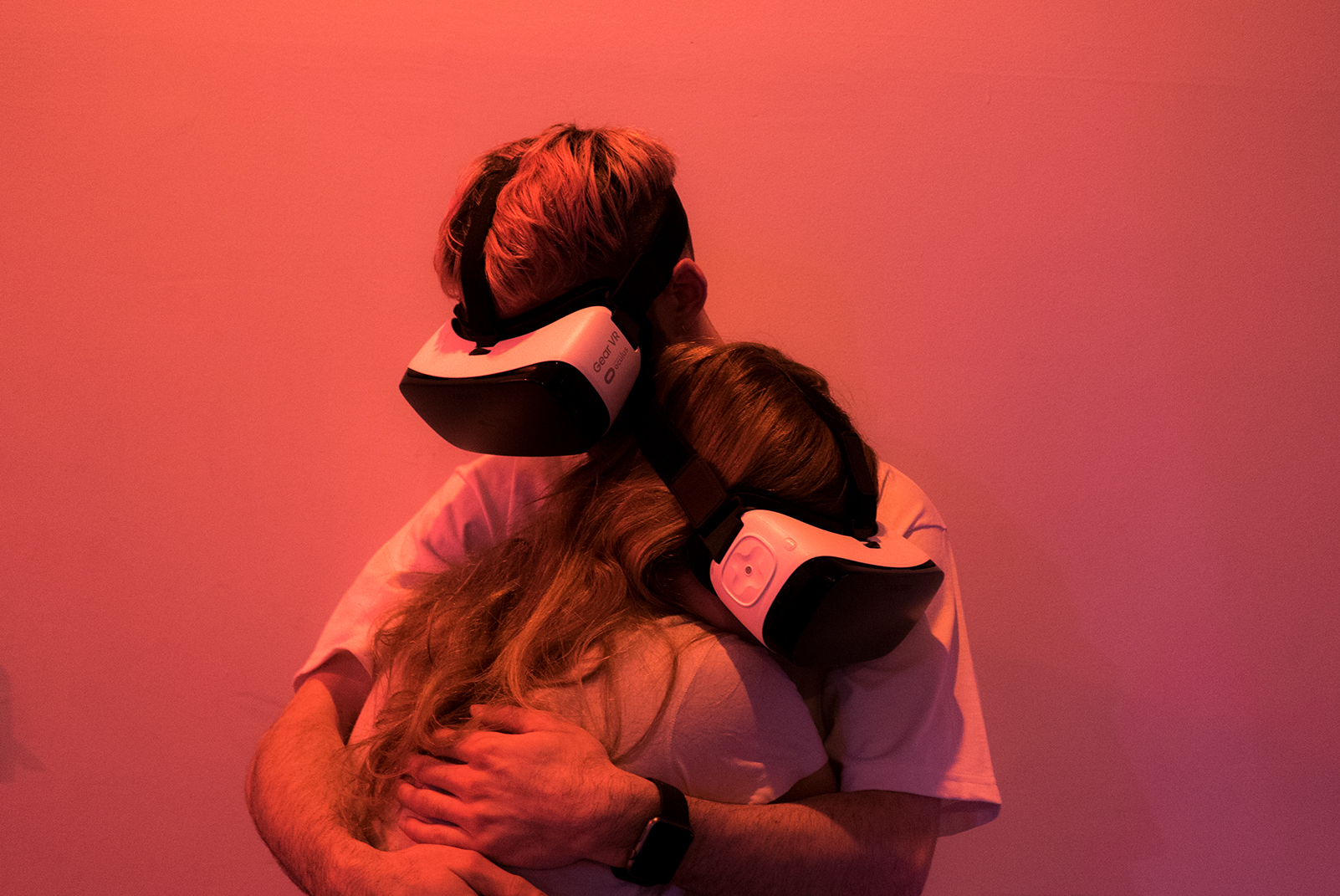 VR Hug - Two people hugging while wearing VR headsets