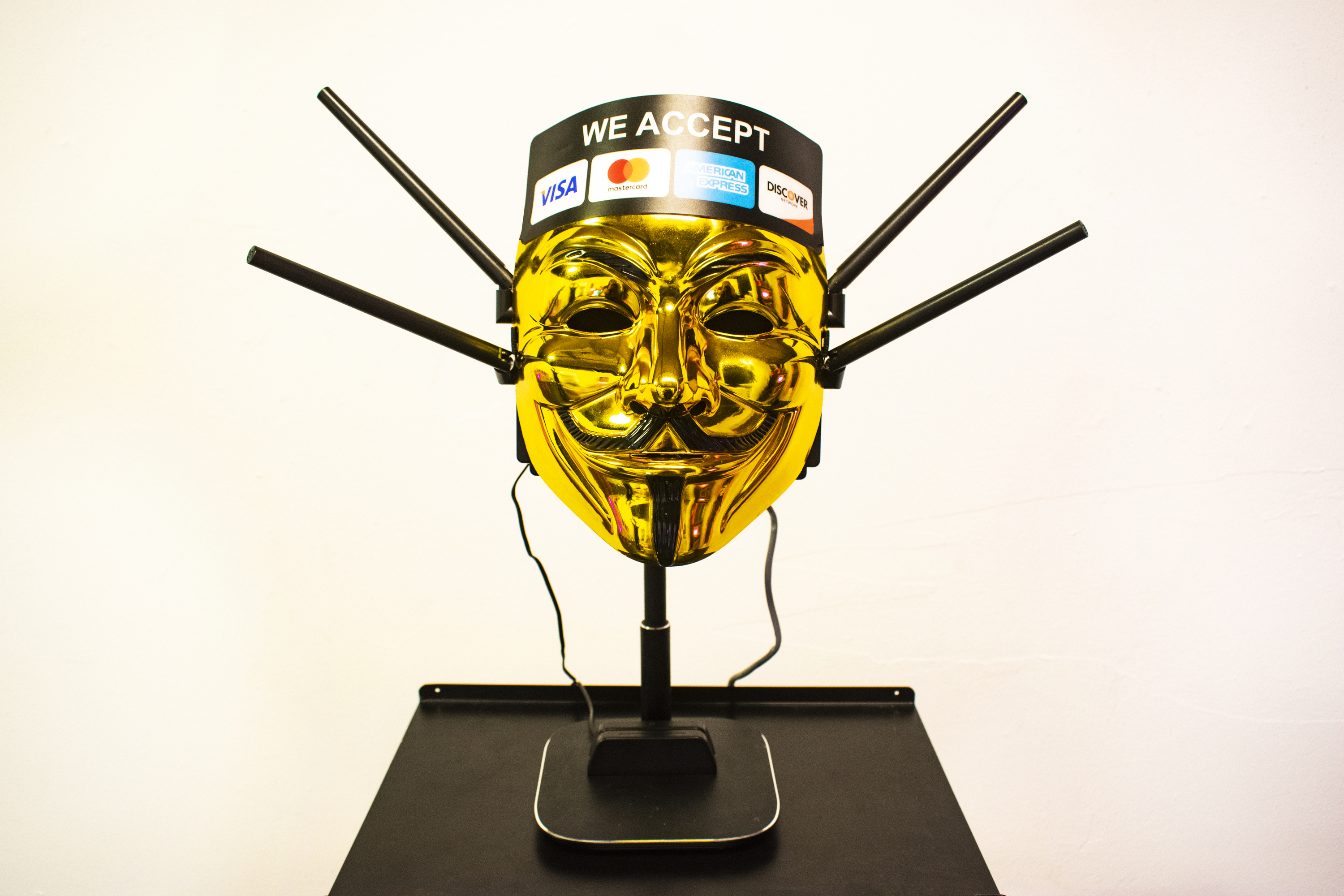 Corporate Anonymity - Gold Guy Fawkes mask with VPN logos and hardware