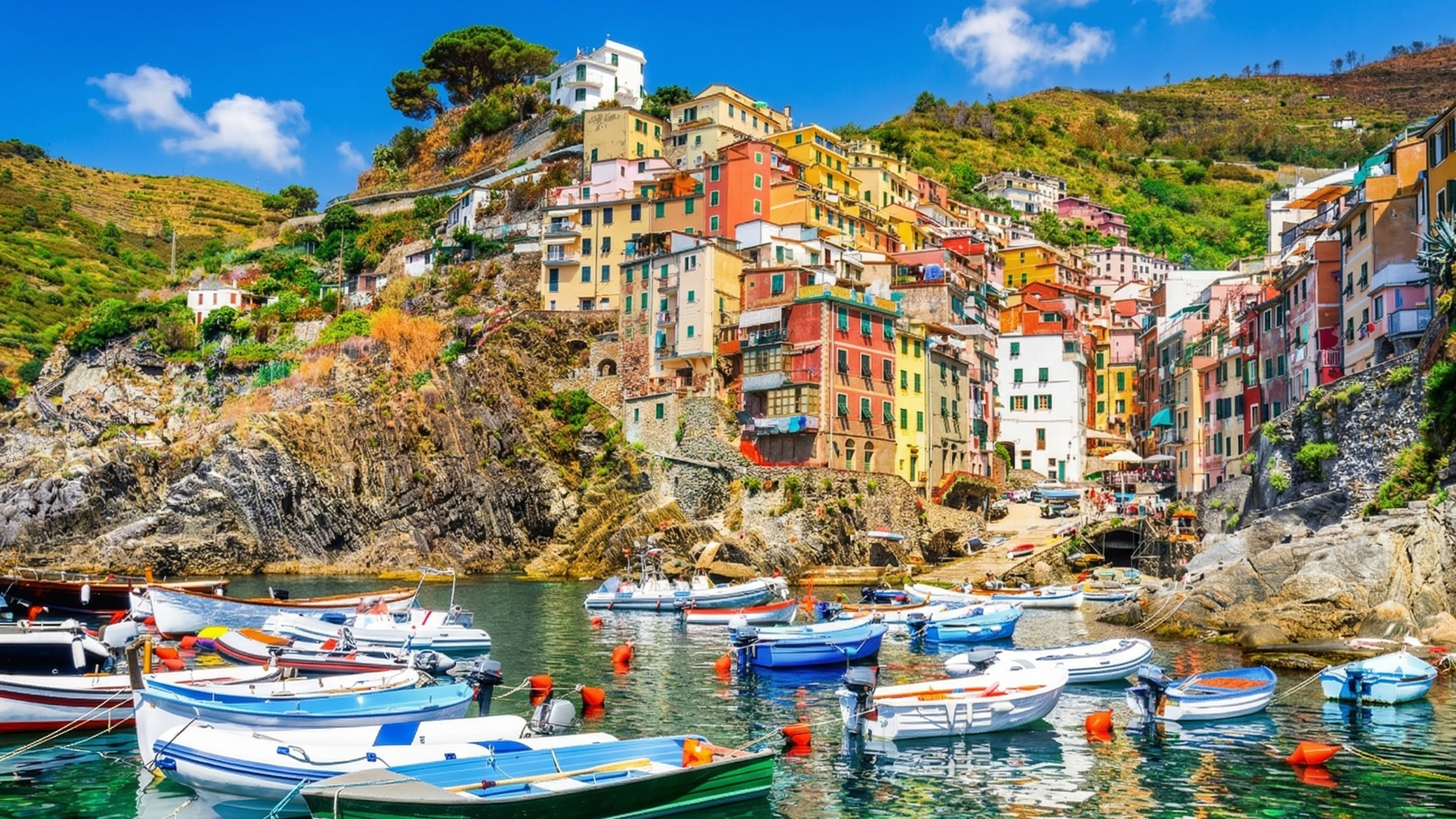 Riomaggiore Cinque Terre colorful stacked houses on rocky hillside with turquoise sea Liguria Italy