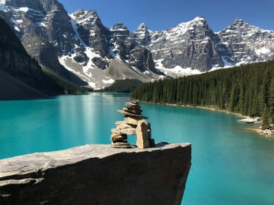 Moraine Lake with rock cairn in foreground and snow-capped peaks, Banff National Park