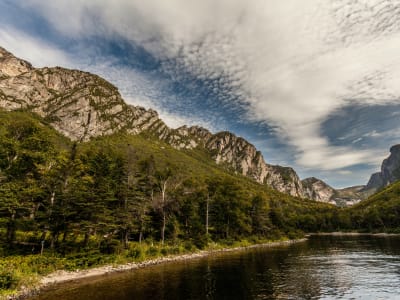 Tranquil lake below dramatic mountain cliffs, Gros Morne National Park, Newfoundland