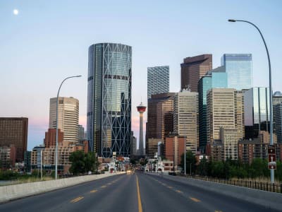Empty highway leading into Calgary skyline at dusk, Alberta, Canada