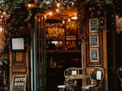 Cozy French café interior with warm lighting, chalkboard menu and vintage decor — a classic family dining experience in France