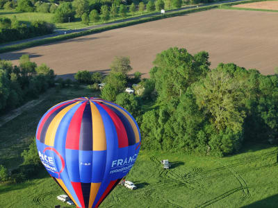Hot air balloon floating above the vineyards and fields of the Loire Valley wine region — a dream family experience in France