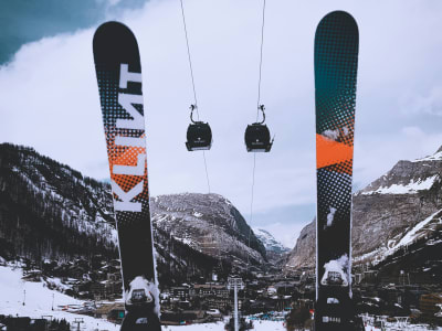 Skis planted in the snow with a chairlift in the background at Val d'Isère ski resort, French Alps France