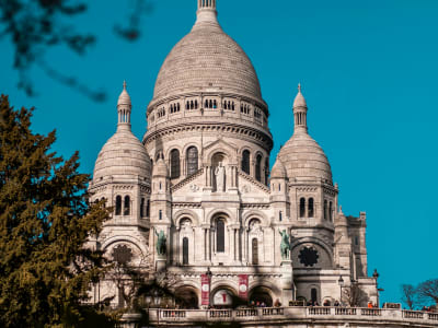 Close-up of the ornate white stone domes of the Sacré-Cœur Basilica in Montmartre, Paris