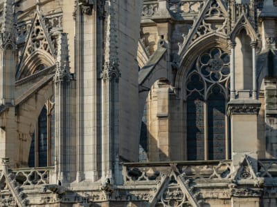 Intricate Gothic stone carvings and rose window detail on the facade of Notre-Dame Cathedral, Paris France
