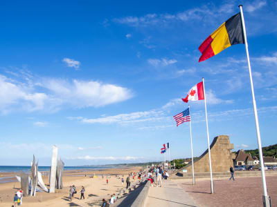 Allied nation flags including Canada and Belgium on a Normandy D-Day memorial beach, France