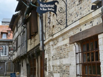 Narrow medieval street in Honfleur with half-timbered houses and cobblestones, Normandy France