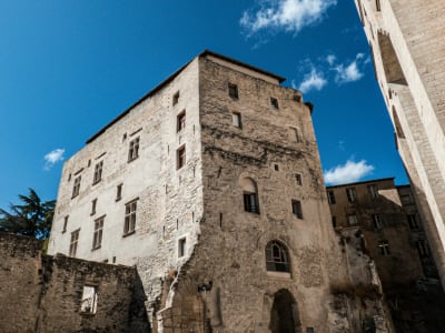 Towering medieval stone walls and battlements of the Palais des Papes in Avignon, Provence France