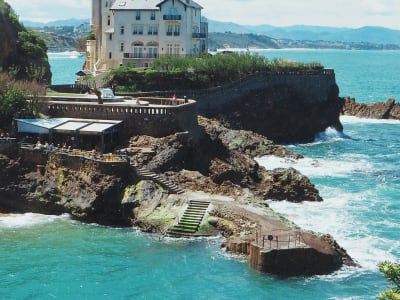 Dramatic rocky cliffs with crashing Atlantic waves at dusk in Biarritz, French Basque Country