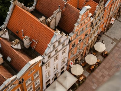 Aerial view of terracotta rooftops and a rooftop terrace in the historic city centre of Bruges, Belgium