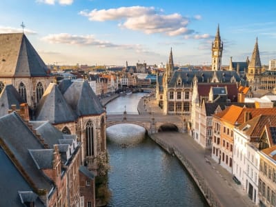 Historic Graslei waterfront with medieval guild houses and Gravensteen castle reflected in the canal in Ghent, Belgium