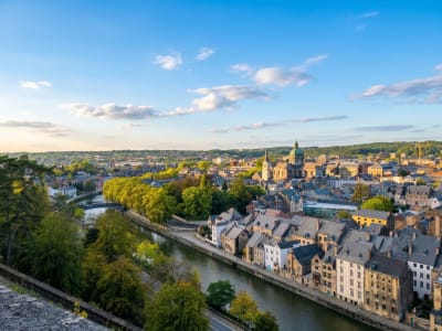 Aerial view of Dinant nestled between the Meuse river and towering limestone cliffs in the Ardennes, Belgium