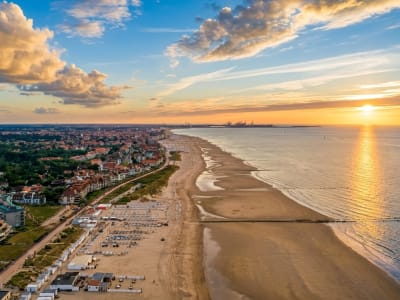 Aerial view of Knokke-Heist beach and coastline bathed in golden sunset light on the Belgian North Sea