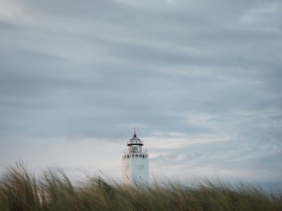 White Noordwijk lighthouse rising above the coastal dunes on the Dutch North Sea coast, Netherlands
