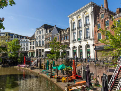 Sunny canal with terrace cafés and historic facades in the centre of Apeldoorn, Gelderland, Netherlands