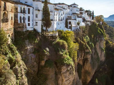 Panoramic view of Ronda old town on the clifftop with the surrounding Andalusian countryside at dusk, Spain