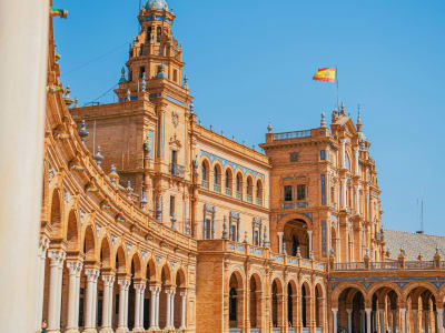 Plaza de España Seville historic building facade with Spanish flag and arched walkways