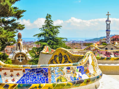 Park Güell Barcelona colorful mosaic colonnade with Gaudí ceramic details and lush garden