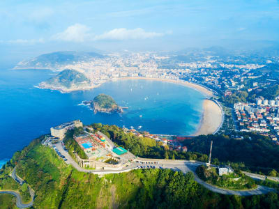 Aerial view of Santa Clara island in San Sebastián bay with La Concha beach and city Spain