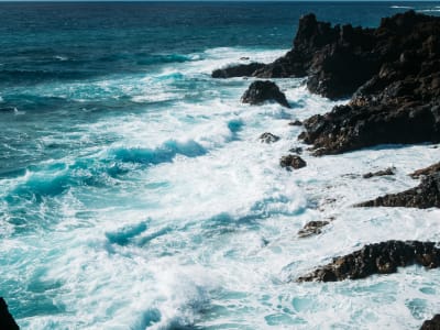 Powerful Atlantic waves crashing over black lava rocks on Lanzarote coastline Canary Islands