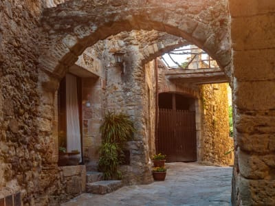 Medieval stone archway and wooden door in Girona Jewish quarter old town Catalonia Spain