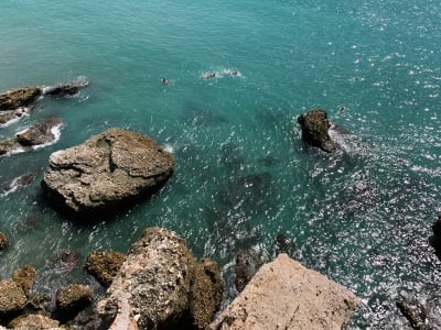Rocky cove with turquoise sea and stone arch at Nerja coastline Costa del Sol Andalusia Spain