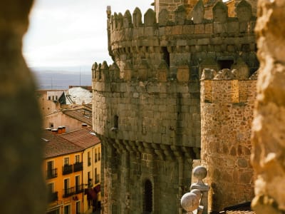 Ávila medieval walls with tower detail and terracotta rooftops of old town Castile Spain