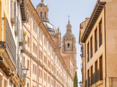 Salamanca old town street with cathedral tower and golden sandstone buildings Castile Spain