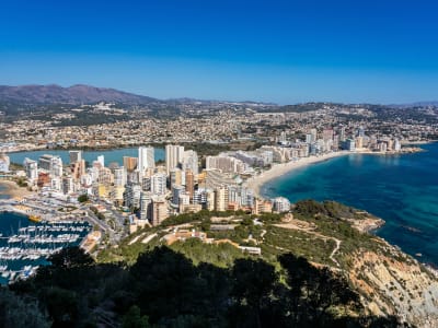 Aerial view of Benidorm Costa Blanca with curved beach high-rise skyline and turquoise sea Spain