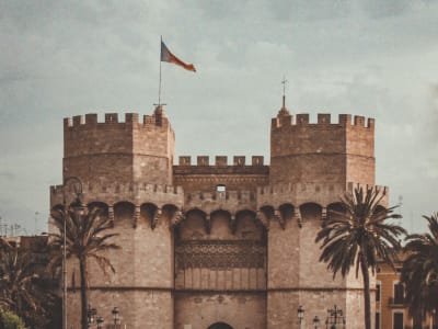 Torres de Serranos medieval gateway tower with palm trees in Valencia old town Spain