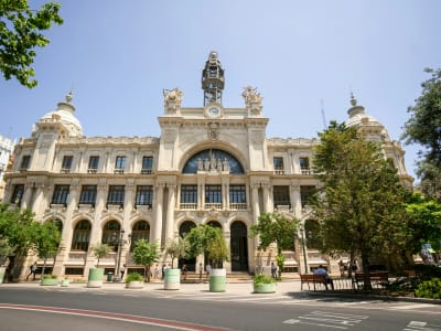 Valencia City Hall building on Plaza del Ayuntamiento with orange trees and blue sky Spain