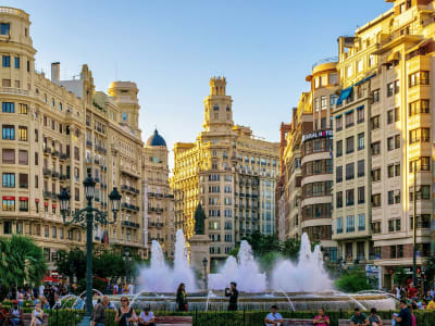 Plaza del Ayuntamiento Valencia with ornate golden buildings fountain and busy square Spain