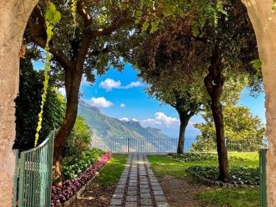 Villa Cimbrone Ravello garden path with flowered archway and Mediterranean sea view Italy
