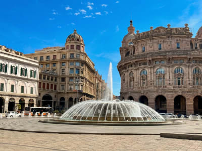 Piazza De Ferrari Genoa with large fountain ornate palazzo facades and pedestrians Italy