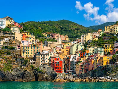 Riomaggiore Cinque Terre hillside village with terraced houses and boats below Liguria Italy