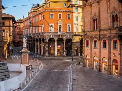 Piazza Maggiore Bologna with red brick arcades and Neptune fountain Emilia-Romagna Italy