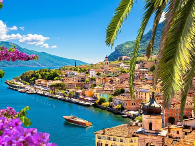 Lake Garda waterfront with pink oleander palm trees and turquoise lake Lombardy Italy