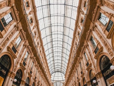 Galleria Vittorio Emanuele II Milan interior with ornate arched arcade and tiled floors Italy