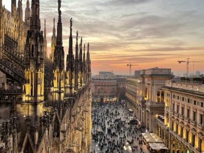 Milan Duomo rooftop view at dusk with Gothic spires and city skyline Lombardy Italy