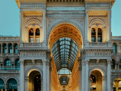 Galleria Vittorio Emanuele II Milan arched entrance with luxury shops and lanterns Italy