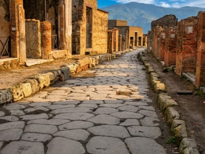 Pompeii Via dell Abbondanza ancient cobblestone road with ruins and stone walls Italy