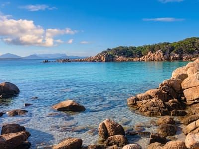 Pink granite rocks and clear turquoise sea along the rugged coastline near Porto Cervo, Sardinia