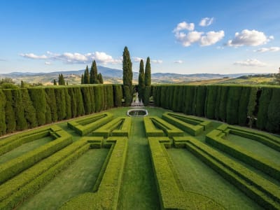 Formal Italian garden with clipped hedgerows and a long cypress-lined pathway at La Foce, Val d'Orcia, Tuscany