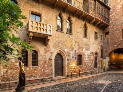Medieval cobblestone street with the famous Juliet's balcony on Via Cappello in Verona, Veneto, Italy