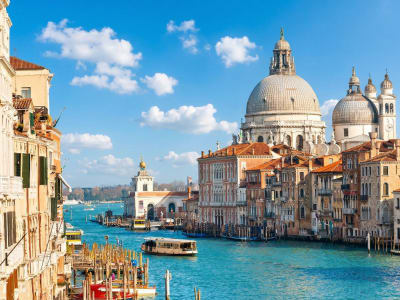 Santa Maria della Salute baroque church with gondolas moored at wooden poles on the Grand Canal, Venice