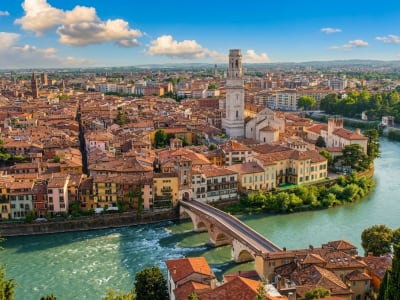 Aerial view of Verona with the Adige river, Ponte Pietra bridge and the city's terracotta rooftops, Italy