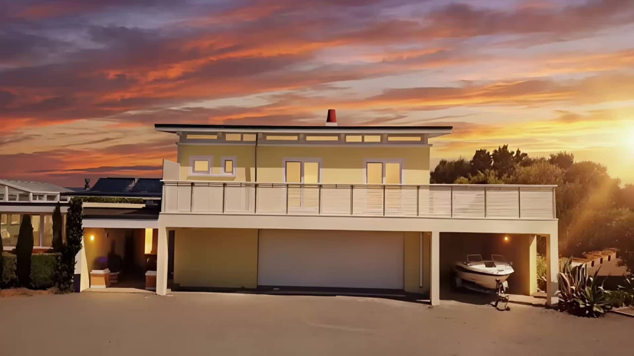 In-law suite in sunset light with a fishing boat on its trailer in the open carport, Bay House Hawke's Bay
