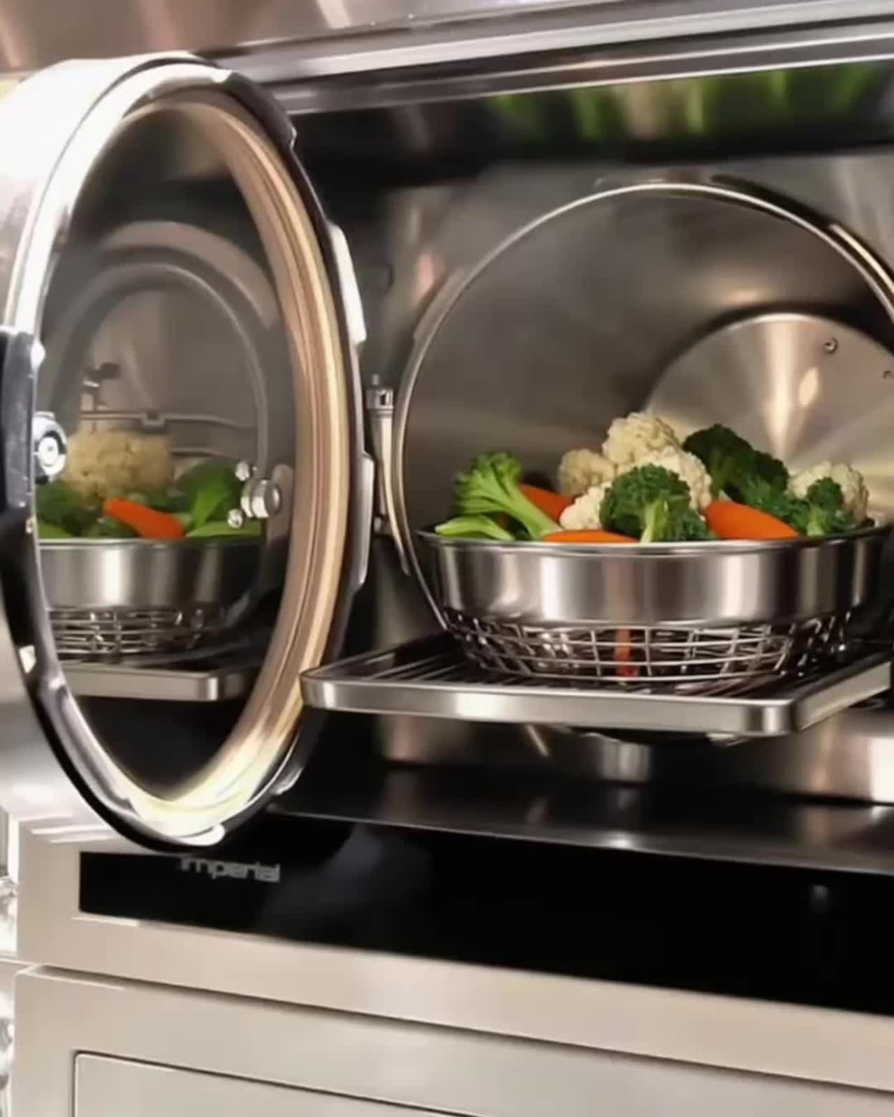 Tray of steamed vegetables sliding from a Miele steam oven in a chef's kitchen, Bay House Hawke's Bay